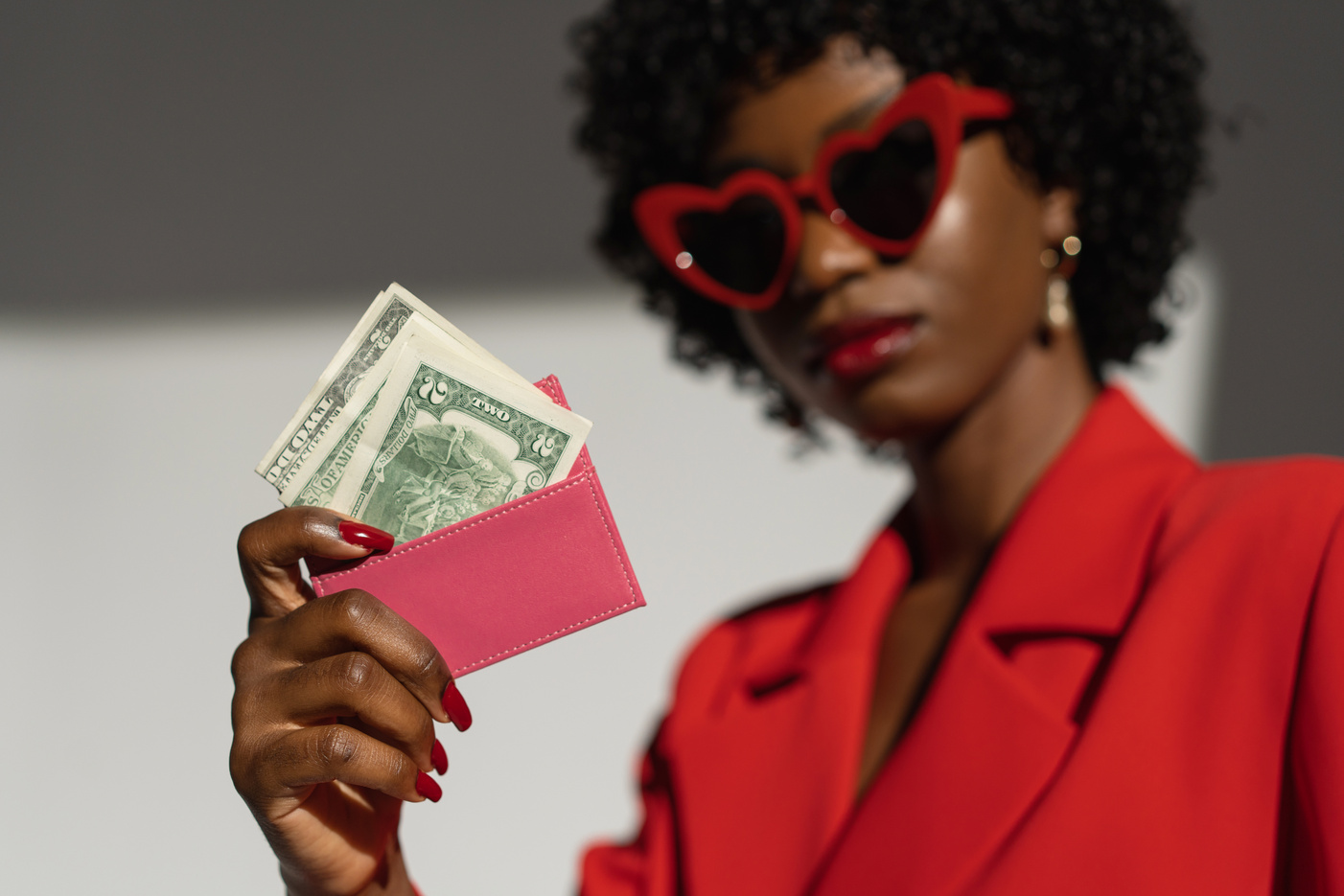 Selective Focus of a Woman Holding a Wallet with Money